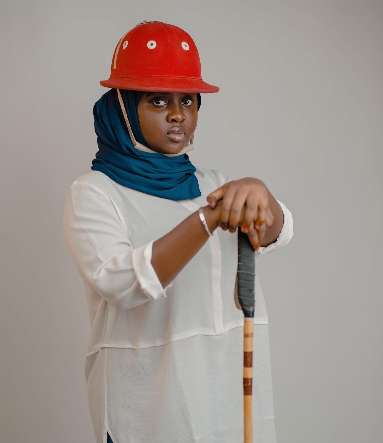 Aisha Ahmad Suleiman with a red polo helmet and mallet